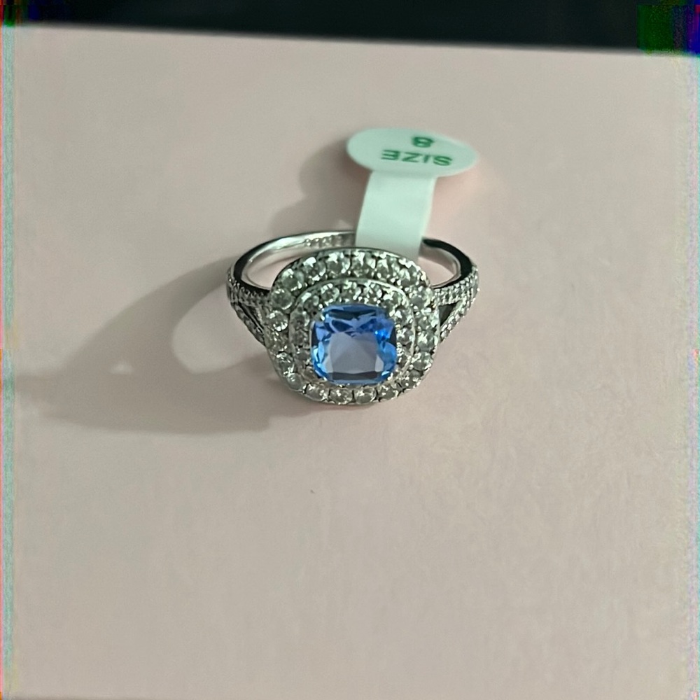NWT-light blue topaz ring on triple rhodium plated band size 8